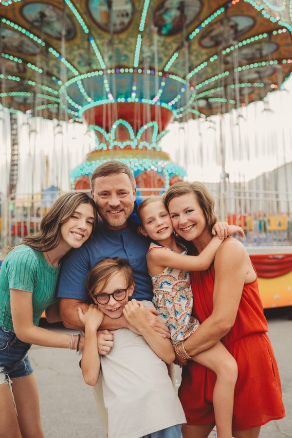 Family posing with Walker Melon at a summer fair